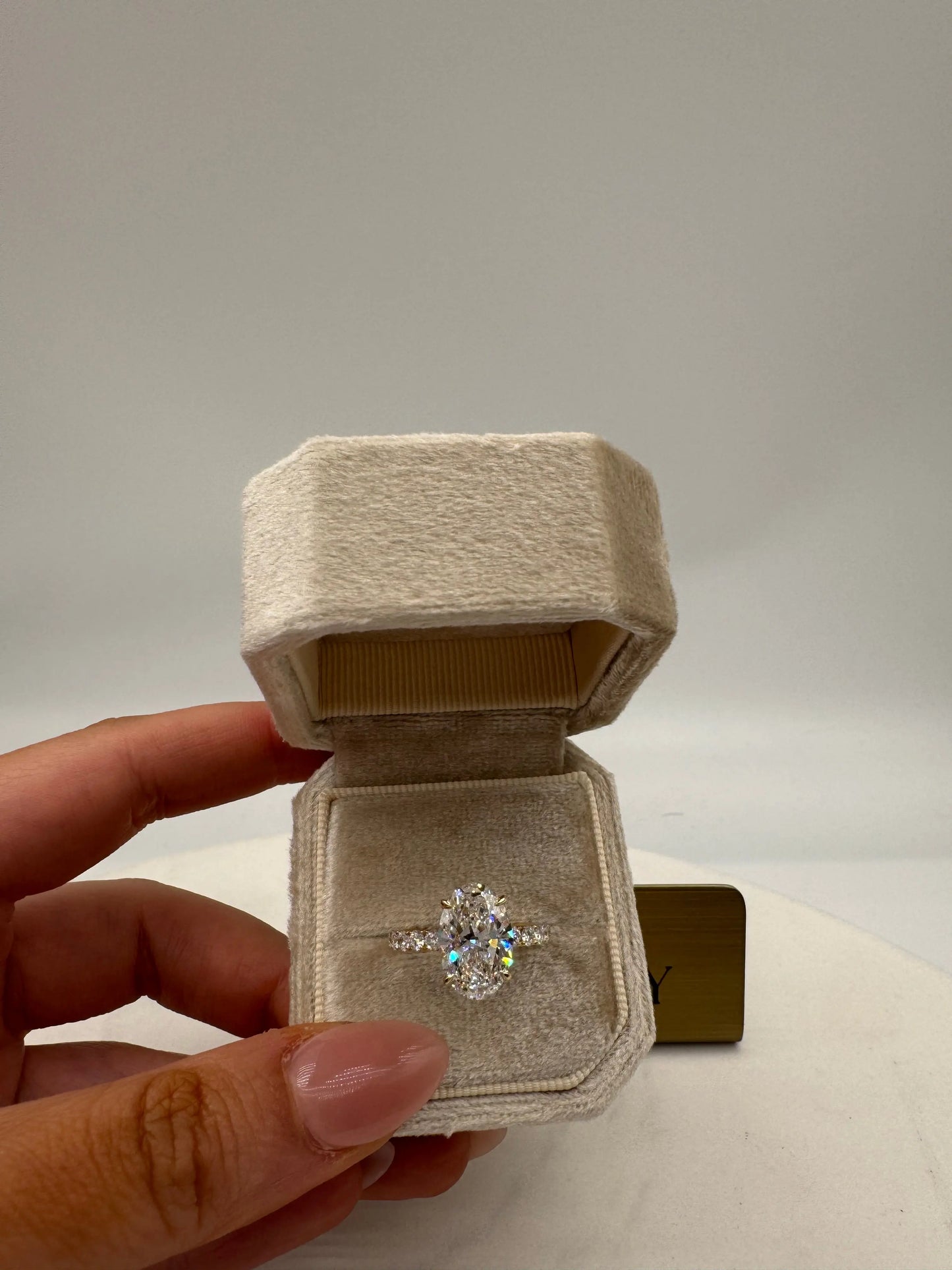 3.51ct oval diamond ring with pavé band and hidden halo