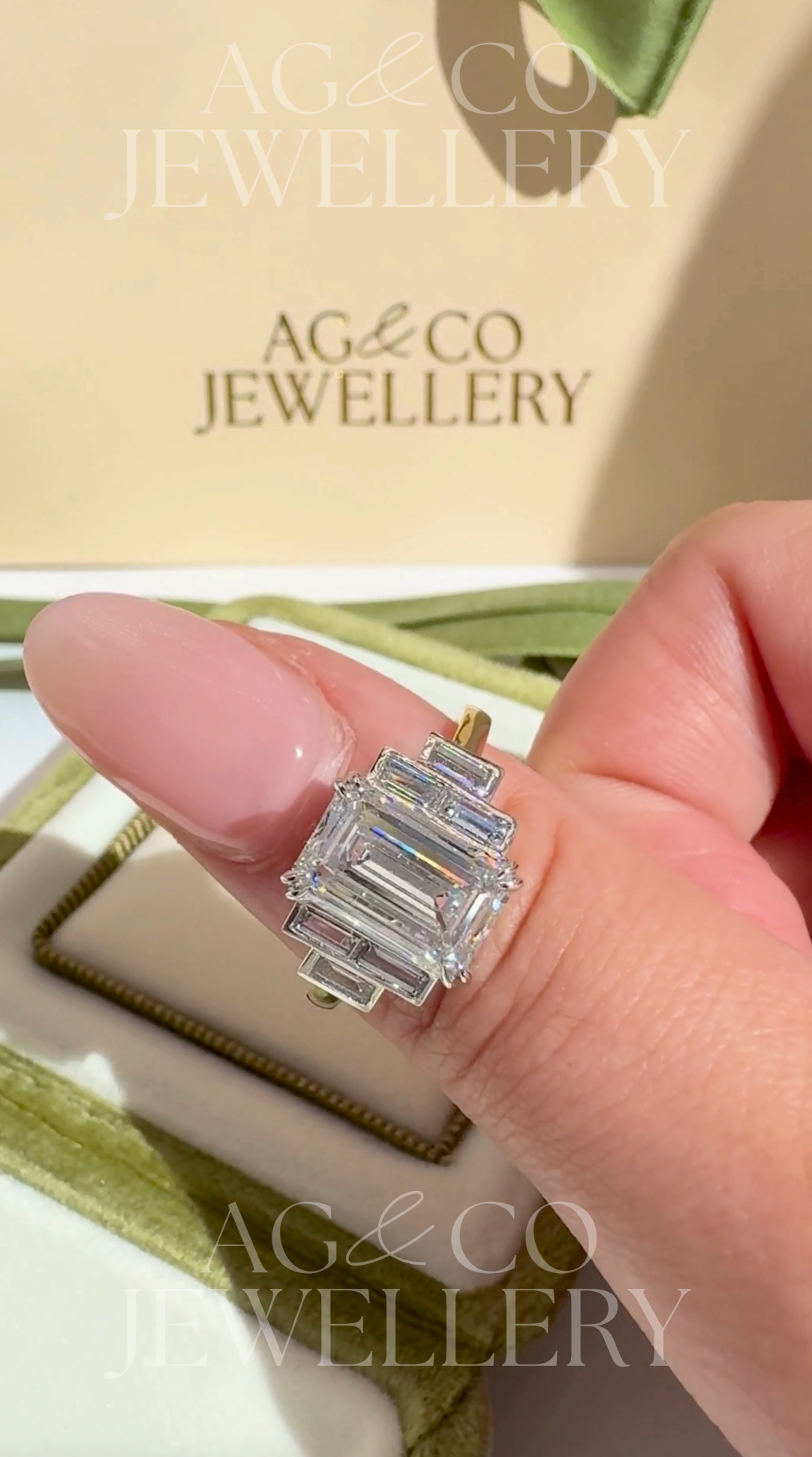 ashira - 5.50ct bezel set 7-stone lab diamond ring with emerald centre stone & baguette side stones ag & co jewellery