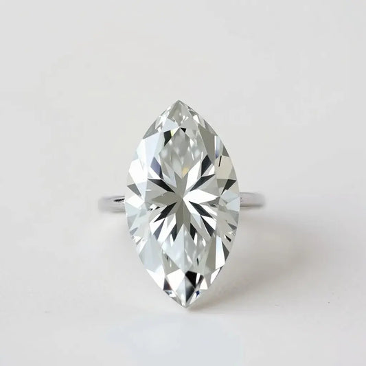 Elongated oval faceted diamond displaying crisp facets and sparkle in a minimal setting