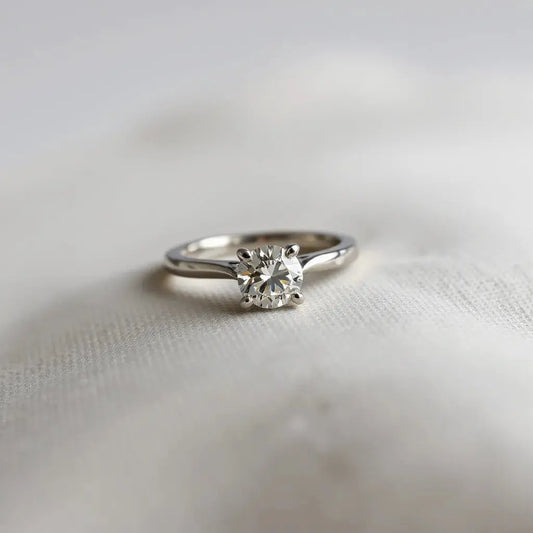 Hidden halo engagement ring with a center diamond and subtle concealed halo under soft studio light