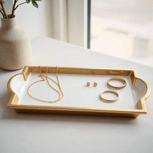 Assorted fine jewelry pieces, including a necklace, earrings, bracelet, and ring, on a neutral display tray.