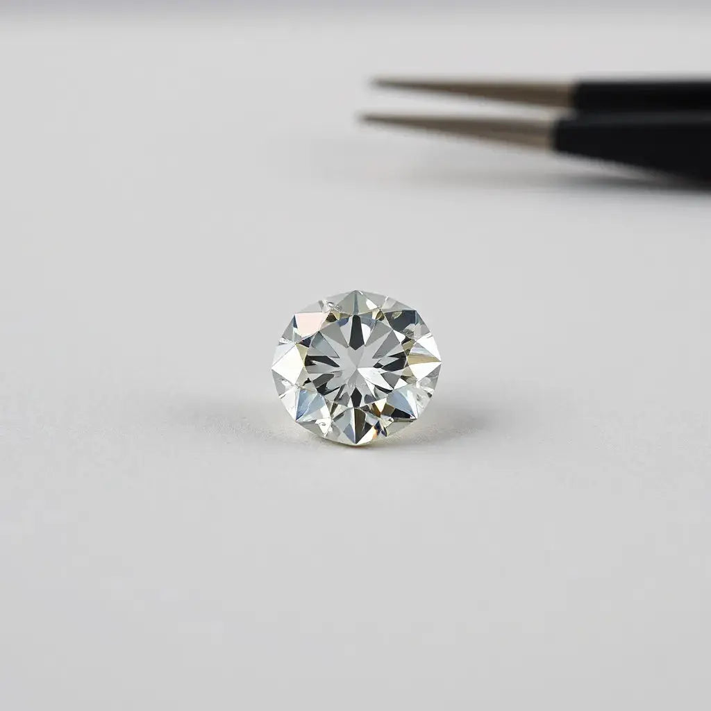 Faceted lab grown diamond resting on a neutral surface with soft studio lighting