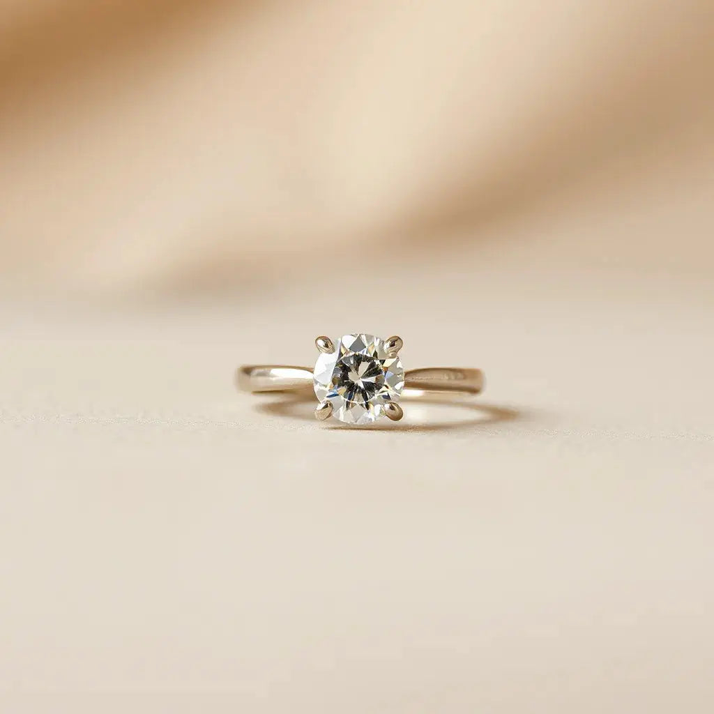 A classic solitaire engagement ring with a single diamond center stone in warm natural light