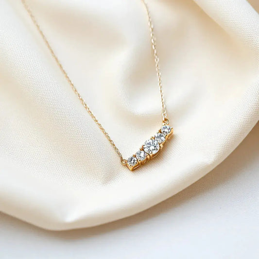 Diamond necklace with delicate chain and sparkling stones on neutral fabric background
