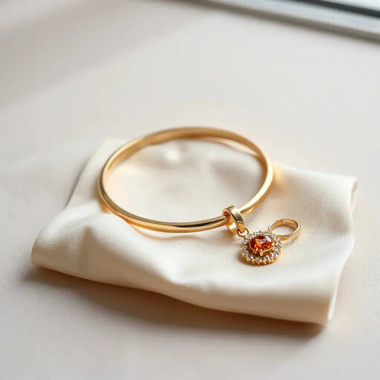 Gold bracelet, diamond ring, and pendant on neutral satin under soft natural light