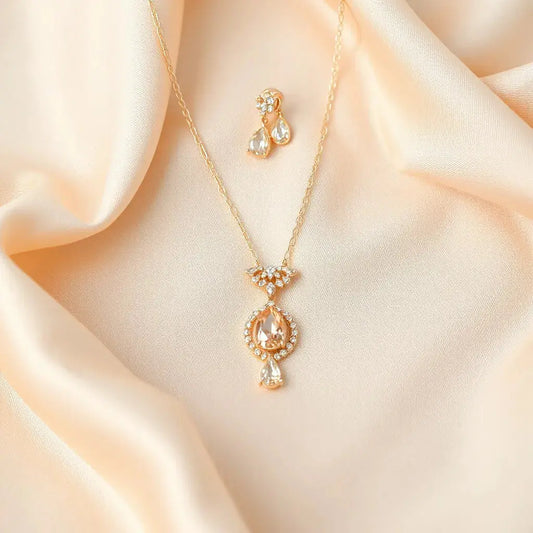 Matching bridal necklace, bracelet, and earrings resting on satin with subtle gemstone sparkle
