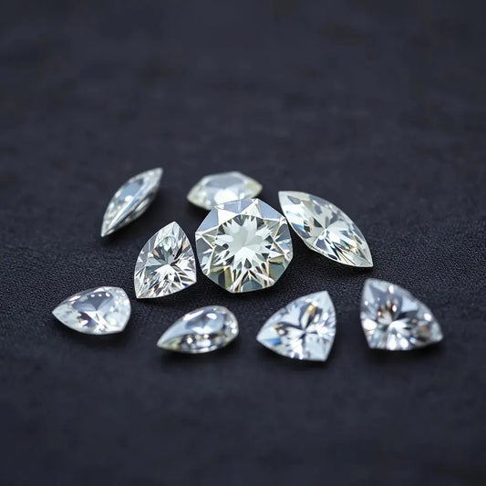 Loose diamonds in different unique shapes on a dark fabric with soft studio lighting