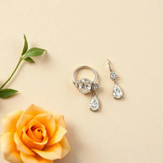 Statement diamond ring and matching drop earrings displayed on neutral velvet under soft daylight