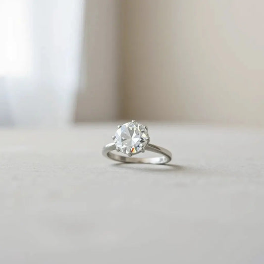 Moval lab diamond solitaire ring with soft natural light and subtle sparkle on a neutral background