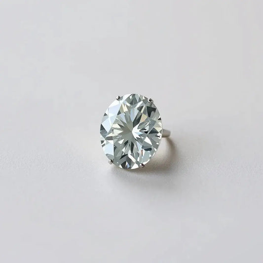 Modified brilliant cut oval diamond with crisp facets in a simple solitaire setting