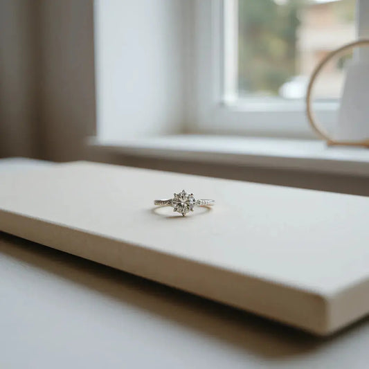Two engagement rings with a solitaire stone and delicate band under soft natural light