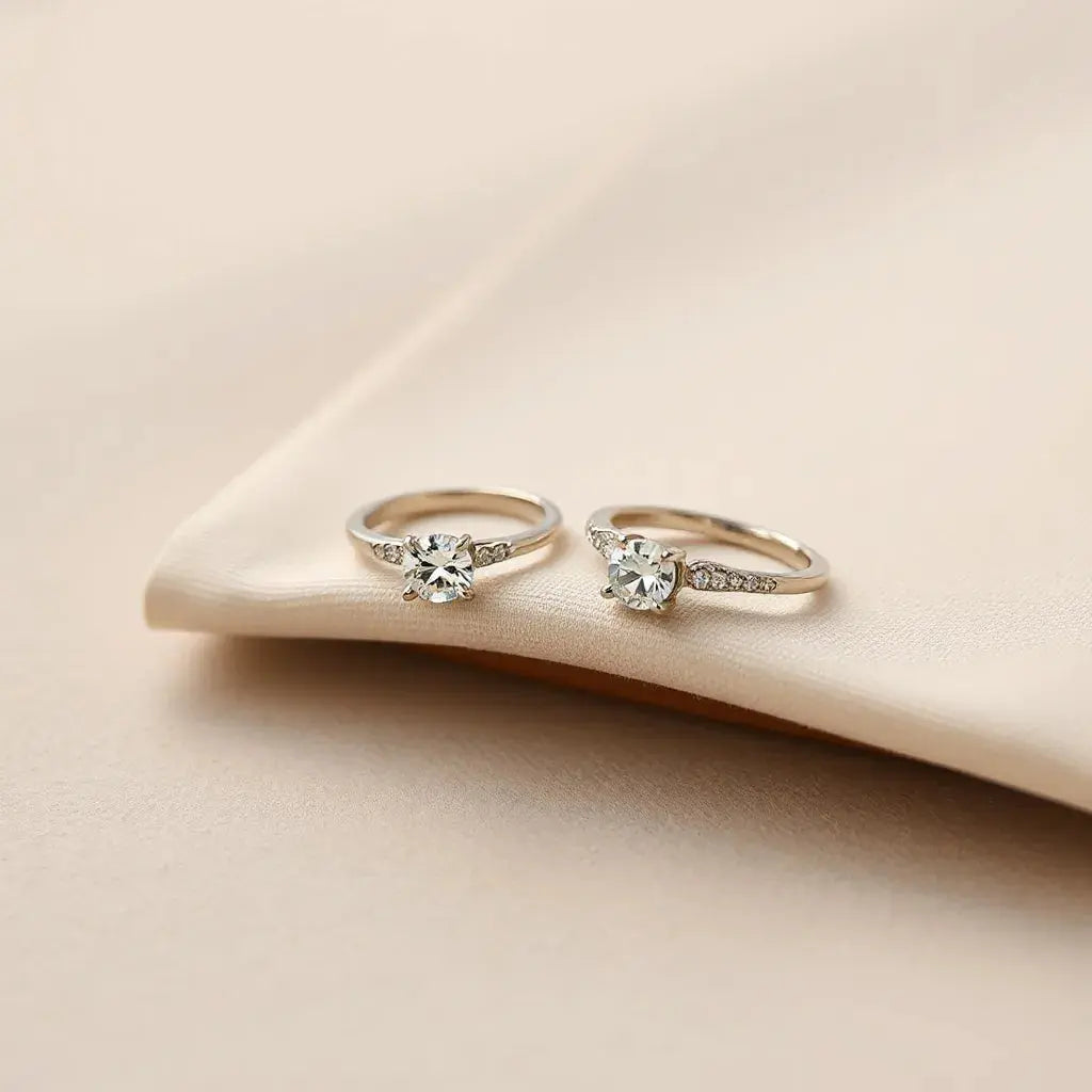 Unique diamond rings displayed on a neutral surface with soft natural light and subtle fabric accents.