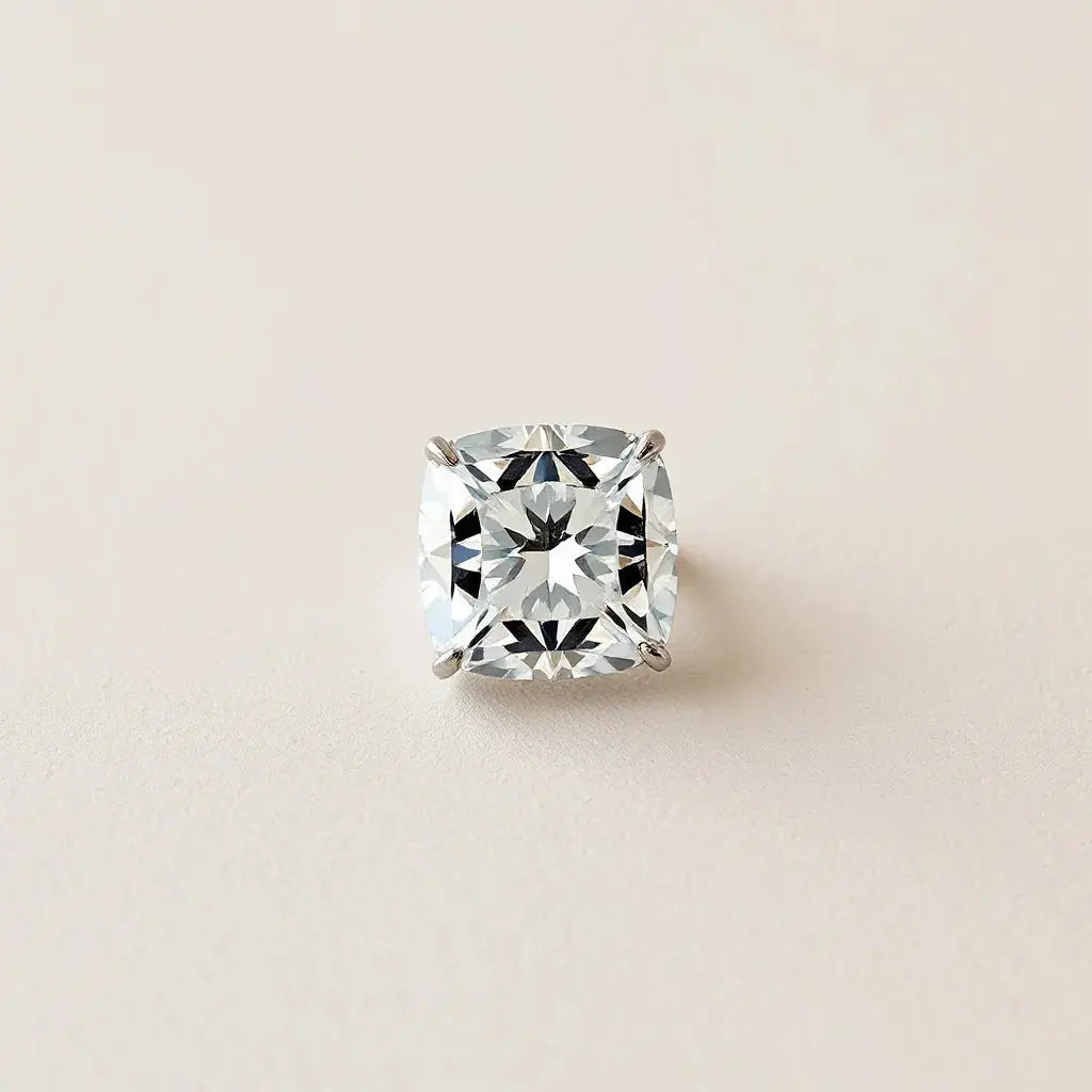 Radiant cut diamond with crisp facets in a simple solitaire setting under soft studio light