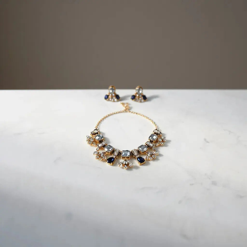 Bold gemstone necklace and matching statement earrings on light marble with soft studio lighting