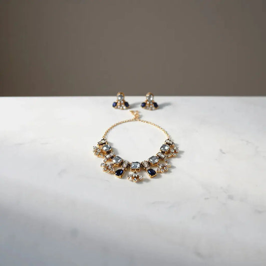 Bold gemstone necklace and matching statement earrings on light marble with soft studio lighting