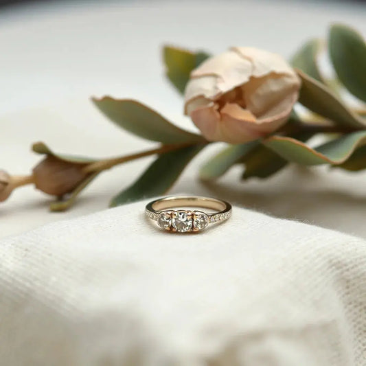 Eco-friendly engagement ring resting on linen with soft daylight and subtle natural greenery