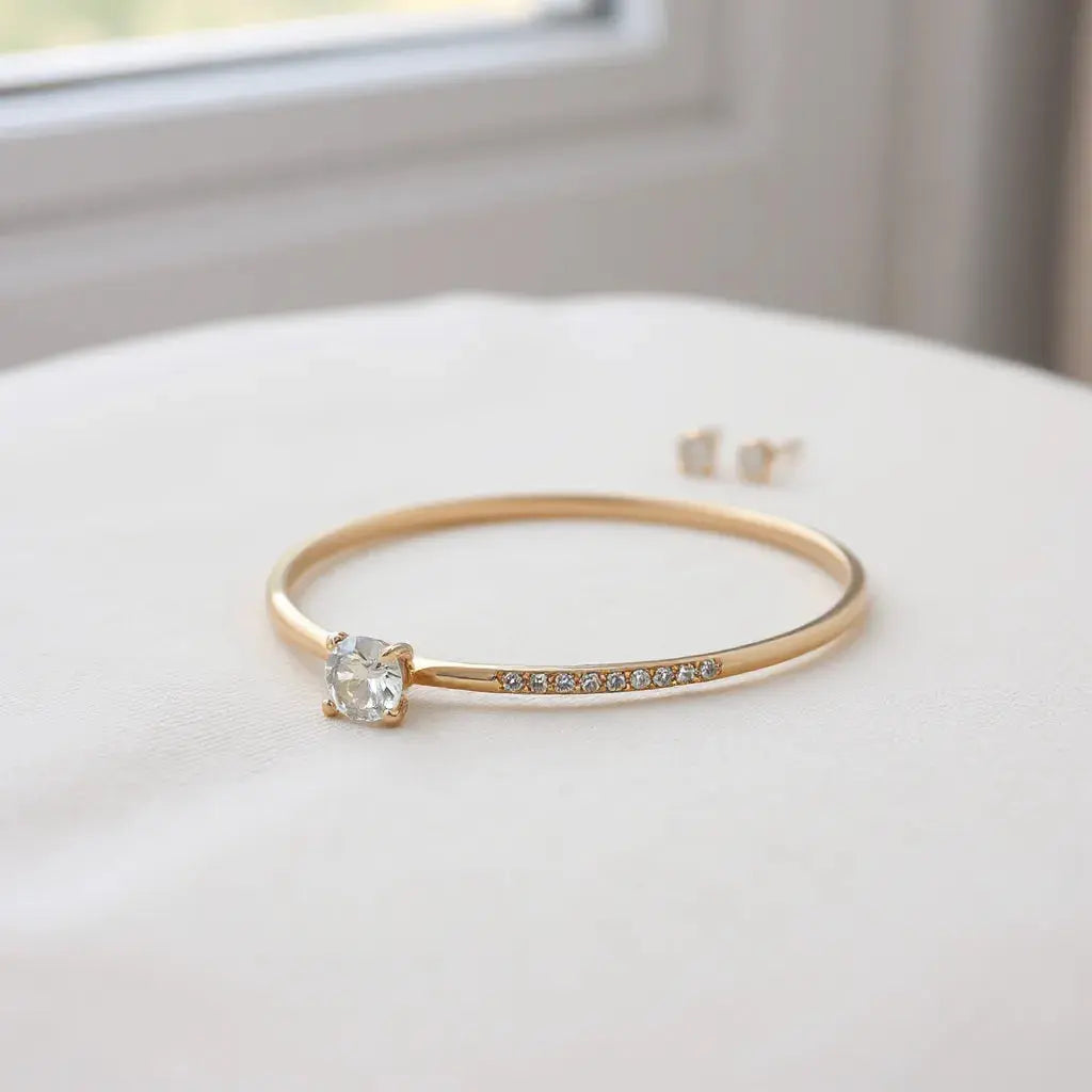 Assorted fine jewellery pieces arranged on neutral fabric under soft natural light