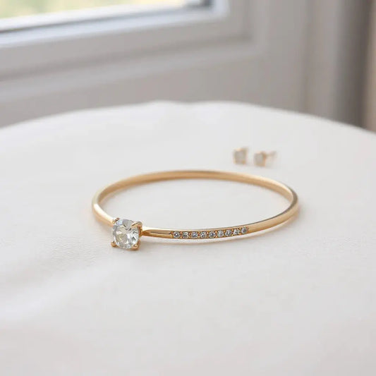 Assorted fine jewellery pieces arranged on neutral fabric under soft natural light