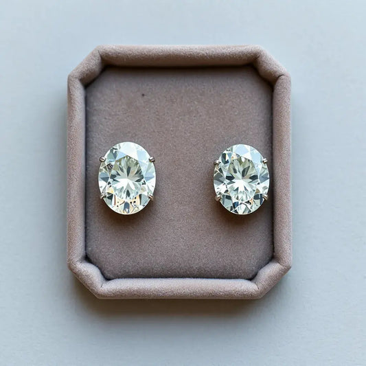 Two side-by-side oval diamond cut samples showing distinct facet patterns under soft studio light