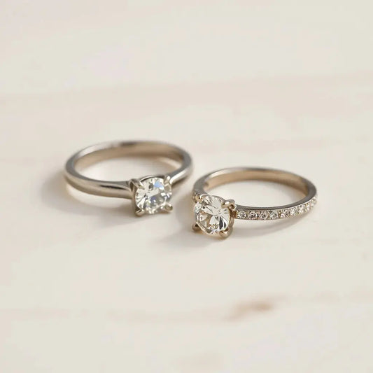 Two luxury engagement rings with diamond solitaire and halo band on a neutral background