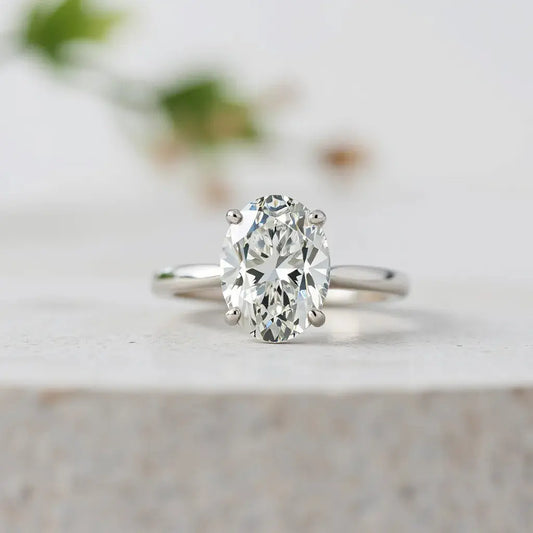 Oval modified brilliant diamond in a minimalist ring setting with visible faceted sparkle
