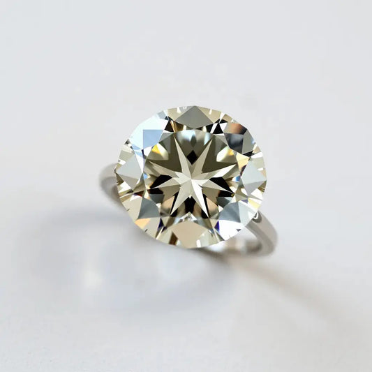 Faceted Portuguese cut diamond ring with crisp highlights on a neutral background