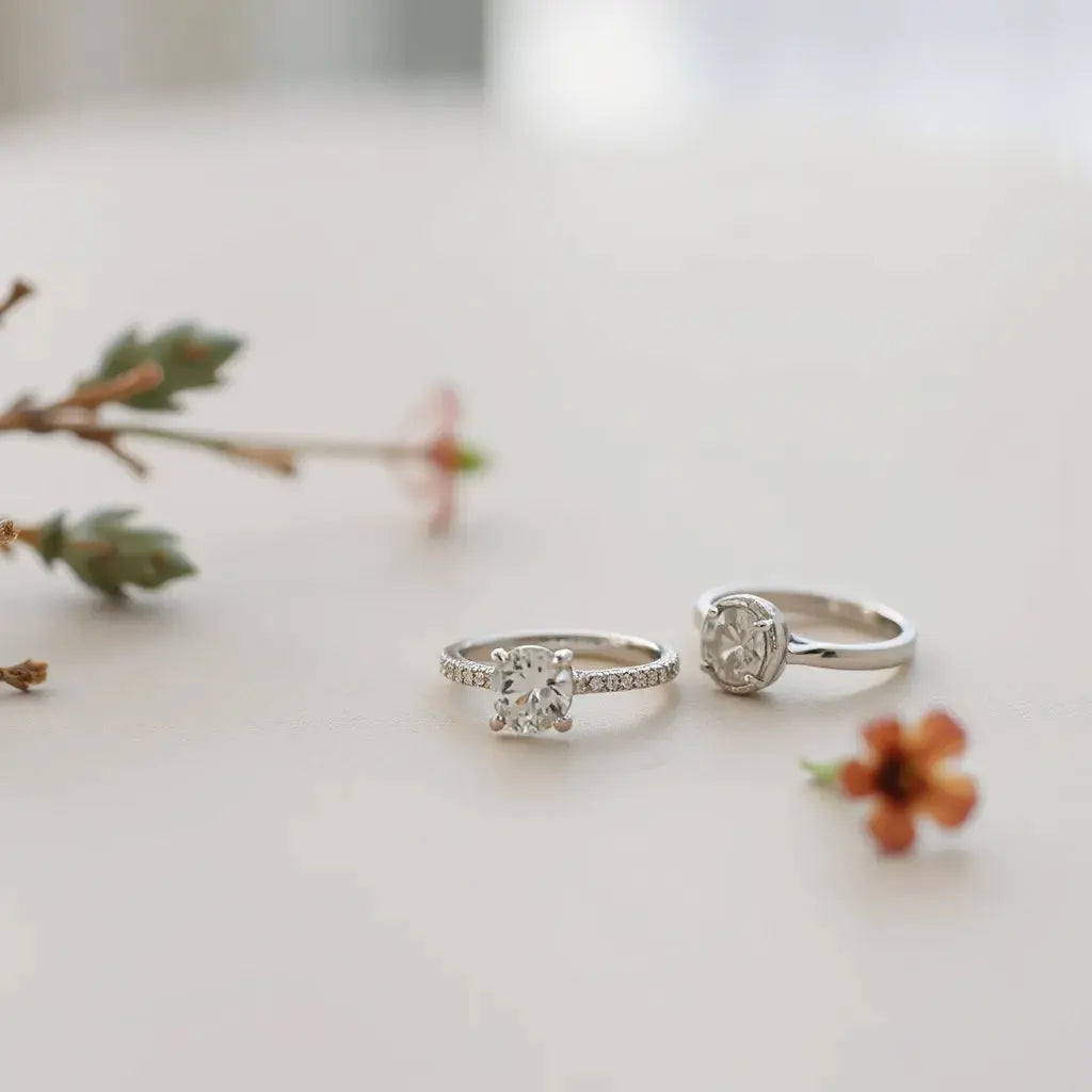 Elegant engagement rings with visible setting details on a light neutral background