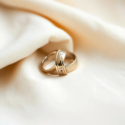 Two engraved wedding bands on neutral fabric with warm natural light and minimal styling