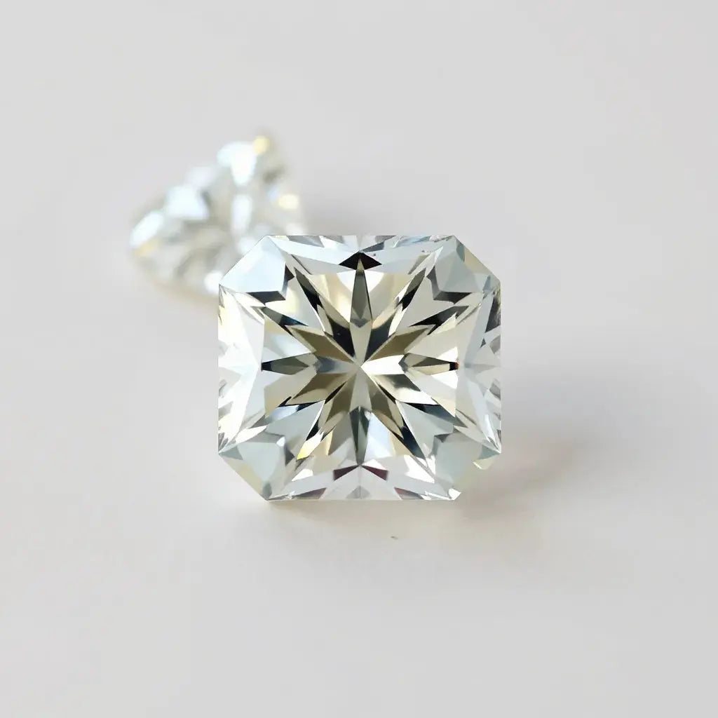 Radiant cut diamond with sharp facets and bright sparkle on a neutral studio background