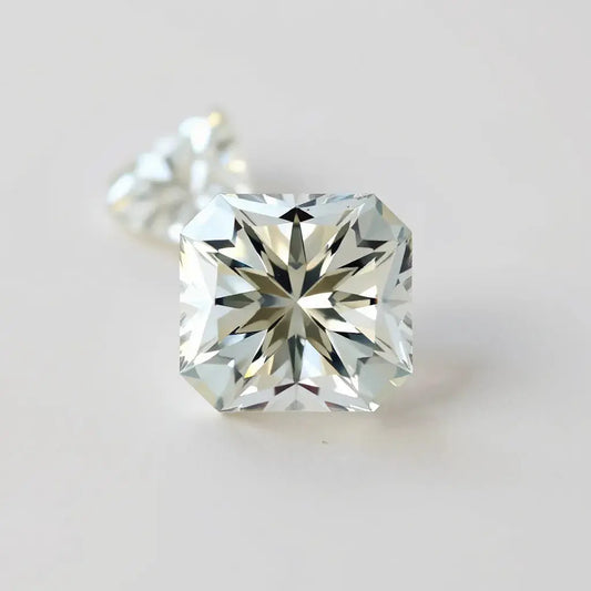 Radiant cut diamond with sharp facets and bright sparkle on a neutral studio background