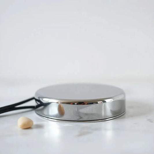 Highly polished metal surface with crisp mirror-like reflections under soft studio lighting