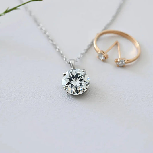 Sparkling diamond necklace resting on light fabric with subtle jewelry accents in soft focus