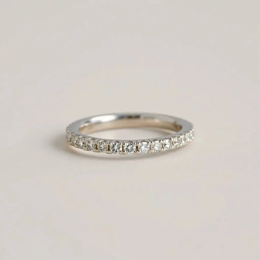 Diamond pavé band ring with closely set stones across the band, shown in soft studio lighting