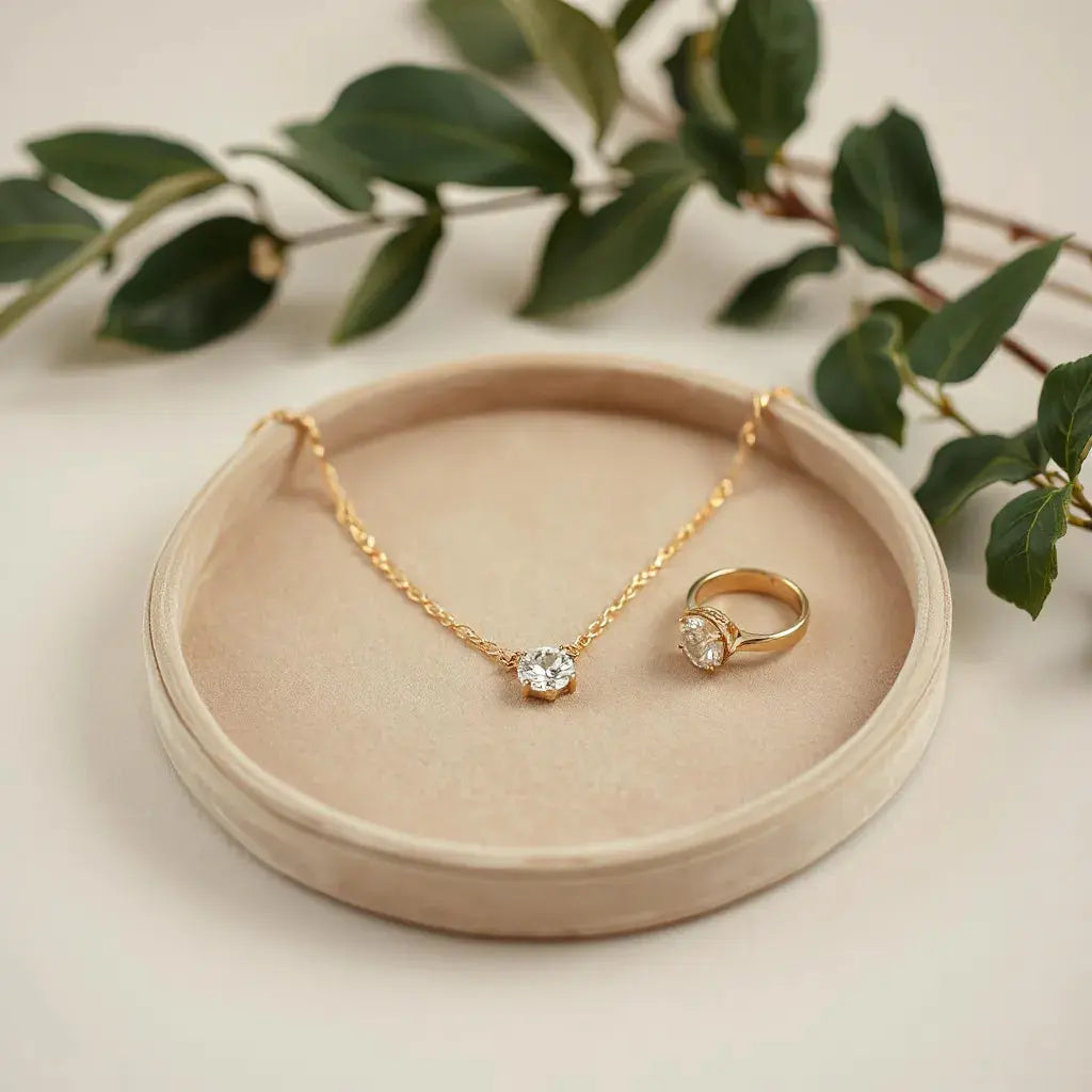 Gold necklace and diamond ring on a velvet tray with soft warm lighting and subtle gemstone sparkle