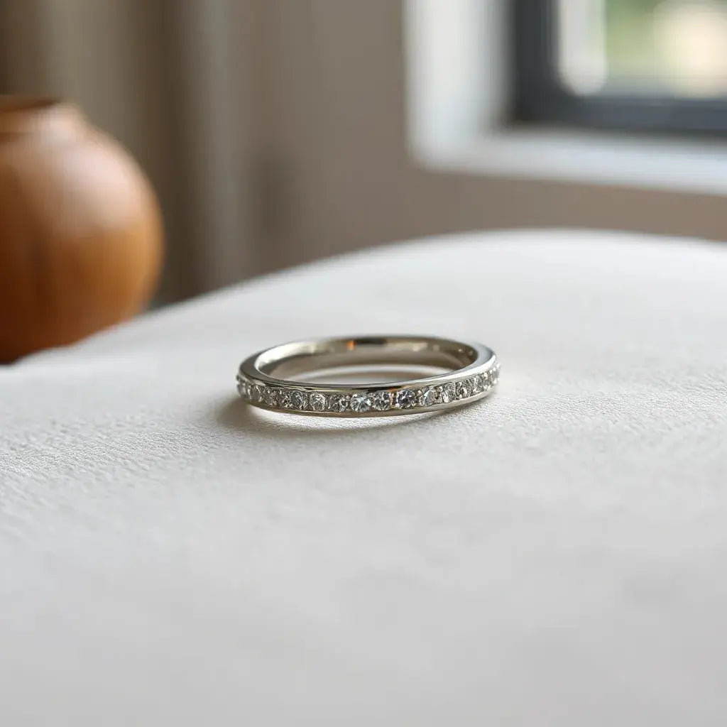 Pavé-set band ring with small stones sparkling under soft natural light on a neutral background