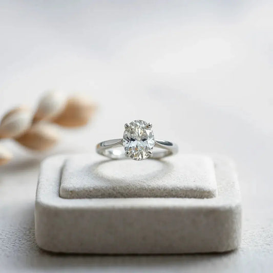 Moval diamond ring with an elongated oval center stone in soft natural light