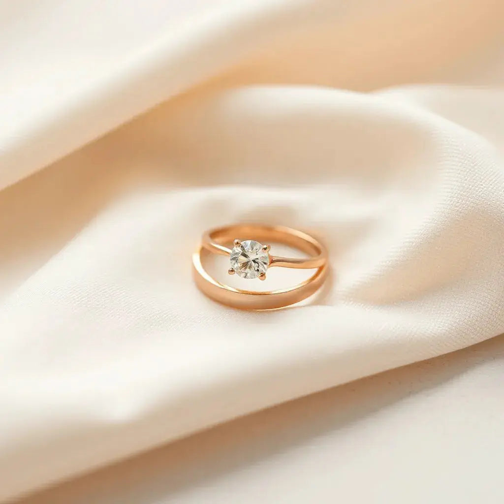 Matching engagement and wedding bands arranged neatly on soft neutral fabric with warm light and gentle sparkle