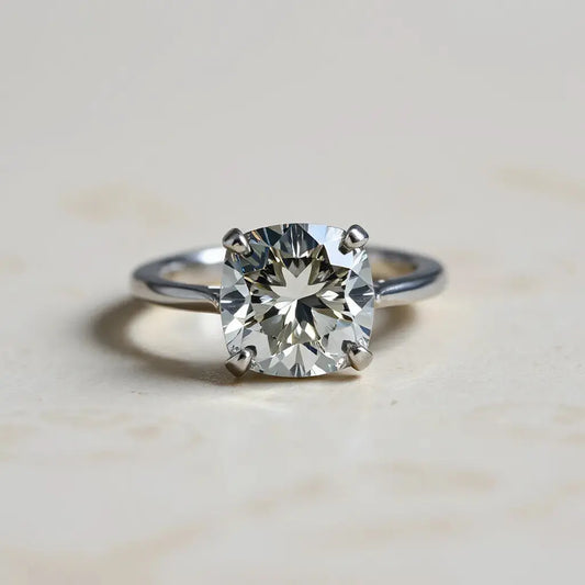 Portuguese cut diamond ring with prismatic facets catching light on a neutral background