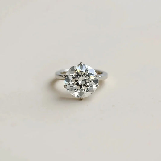 Portuguese cut diamond engagement ring with bright reflections on a neutral background