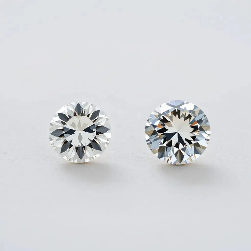 Two diamonds, a moval and an oval, displayed side by side with visible faceting and settings