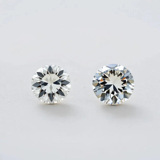 Two diamonds, a moval and an oval, displayed side by side with visible faceting and settings