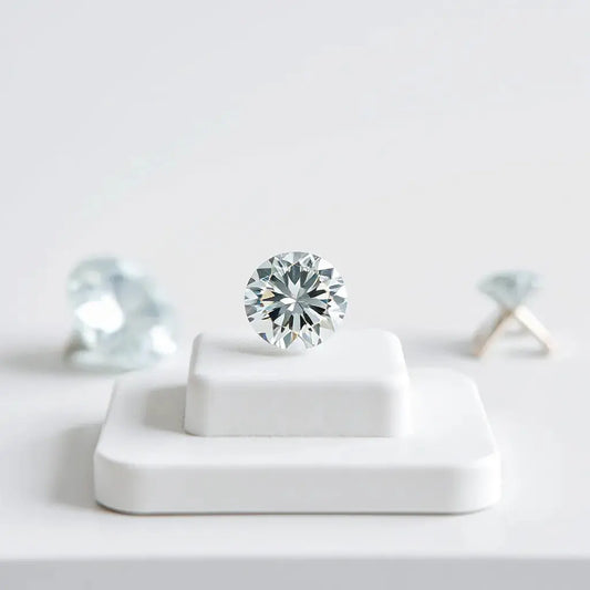 Lab grown diamond solitaire with visible facets on a minimal white display stand