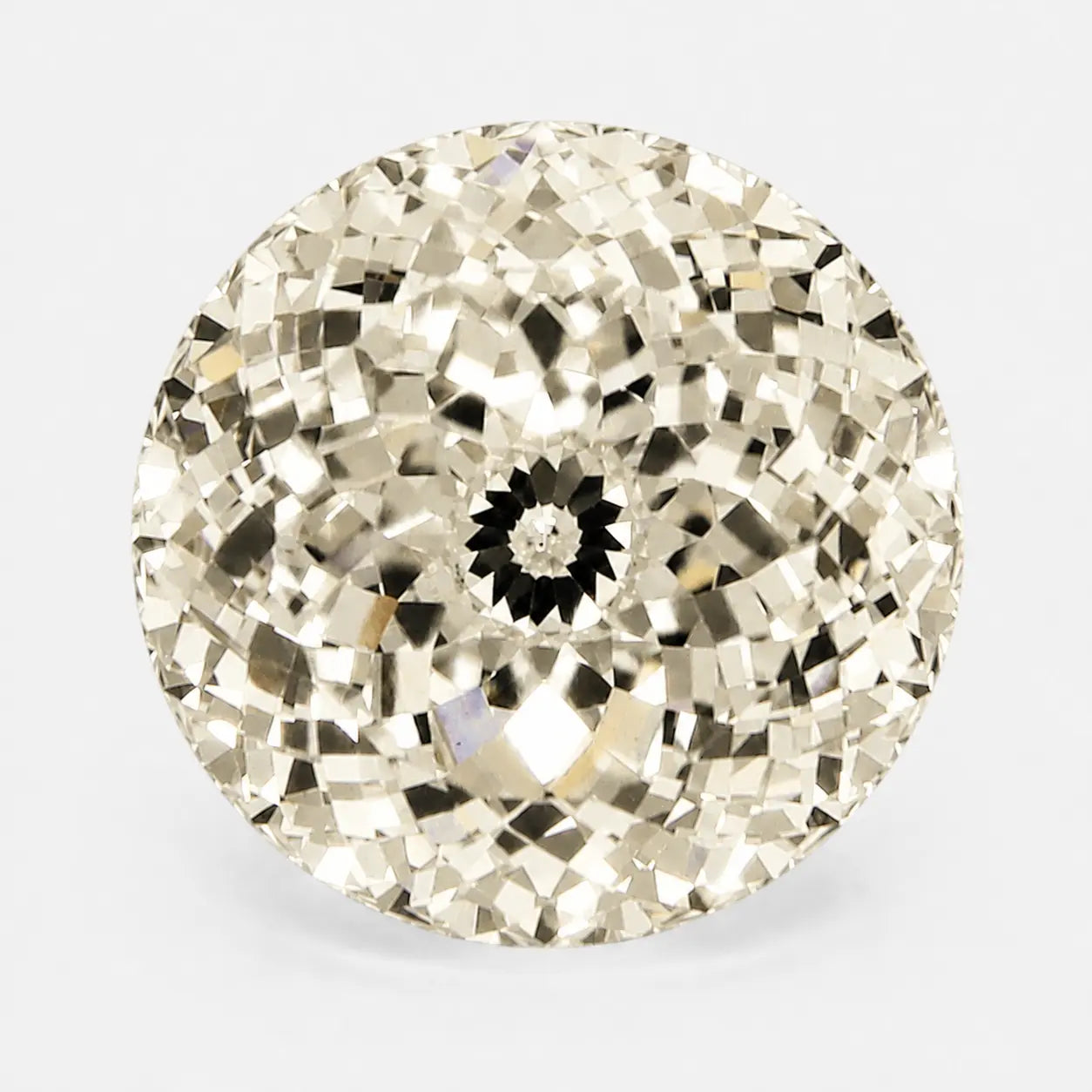 round portuguese diamond in a soft light yellow tone
